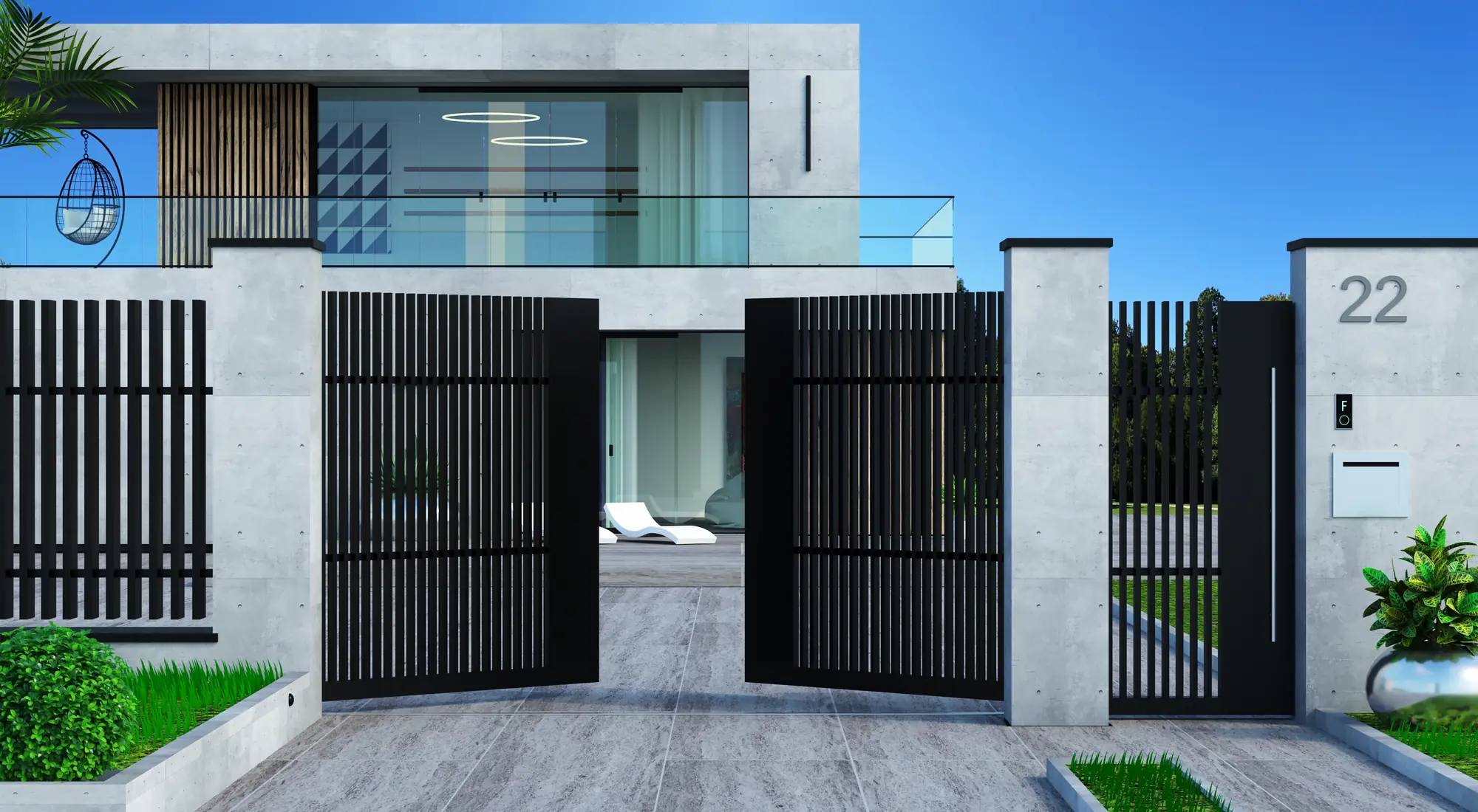 Portail automatique et portillon assorti fermant l’entrée d’une villa, allée pavée en premier plan